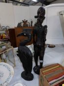 A carved wood figure and a carved wood stork