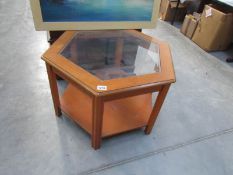 A teak coffee table with glass top