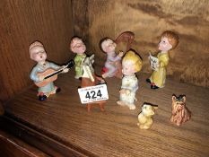 A rare 8 piece Beswick children's choir (5 children, 1 piano, cat and dog)