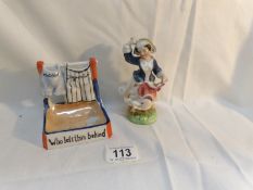 A vintage novelty match striker and a Victorian figure