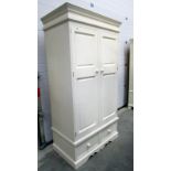 A painted wardrobe with drawer base