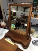 A mahogany toilet mirror