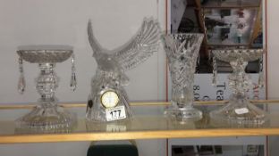 A pair of cut glass candlesticks, a cut glass vase and a cut glass eagle clock