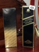 A boxed bottle of Johnnie Walker and a boxed bottle of Teacher's whisky