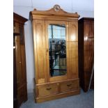 A pine wardrobe with mirrored door