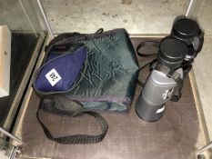 A pair of Olympus 10 x 50 binoculars and a camera