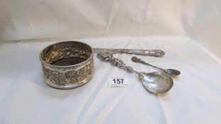 A silver handled cake knife, a silver plated wine coaster and 2 decorative spoons