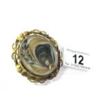 An Antique swivel hair brooch with locket back