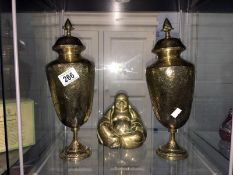 A pair of brass lidded vases and a brass Buddha figure