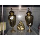 A pair of brass lidded vases and a brass Buddha figure