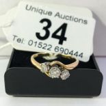 A 2 stone 18ct gold cross over ring, size P
