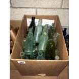 A box of vintage glass bottles including cod bottles