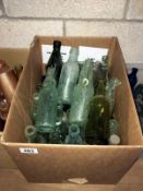 A box of vintage glass bottles including cod bottles