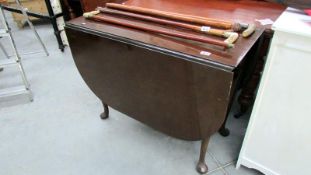 A drop leaf table on pad feet