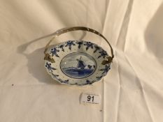 An unusual Delft blue and white dish with white metal handle