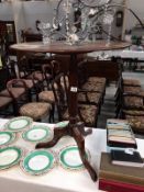 A mahogany tripod table