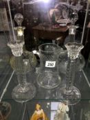 2 glass decanters, a pair of glass candlesticks and a glass jug