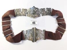 A nurses belt with white metal buckle and fittings