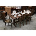 An oak refectory table with a set of 6 wheel back chairs