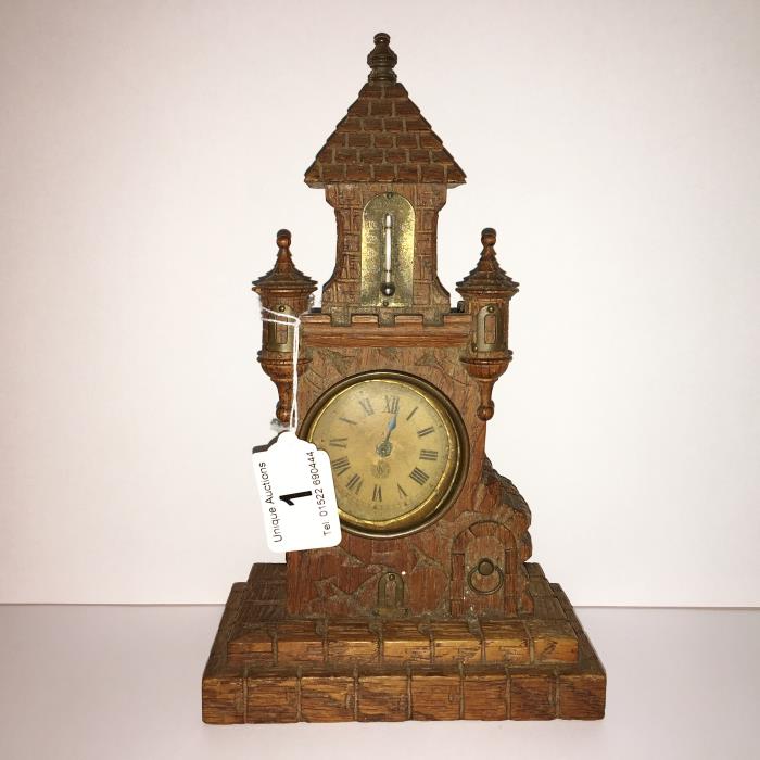 A carved oak black forest clock thermometer in the form of a castle