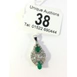 An 18ct gold emerald pendant set with diamonds as baguettes and brilliants