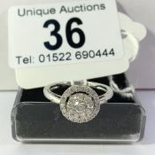 A 9ct white gold half carat circular diamond ring, size Q