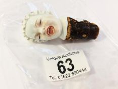 A Meissen porcelain bottle stopper of a maid wearing a bonnet (cork a/f)