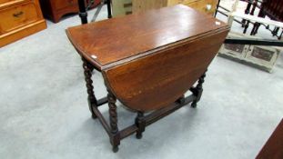 An oak barley twist gate leg table