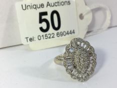 A 9ct white gold ring set diamonds, (one stone missing)