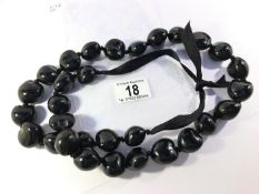 A string of large black beads