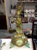 A French mantel clock surmounted figure