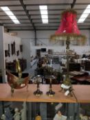 A brass based table lamp, a pair of candle stands and a small copper coal helmet