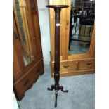 A mahogany torchere with reeded support