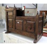 An oak cradle with secret cupboard and secret drawer