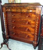 A 2 over 3 mahogany chest of drawers with flame mahogany panels and twisted pillars