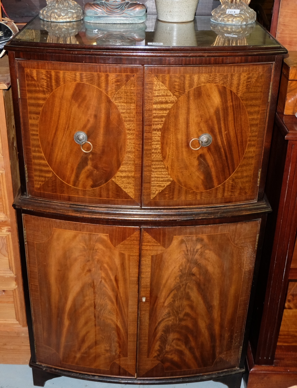 Mahogany Bow-front 4-door Drinks Cabinet, the top two doors opening to satinwood interior, with