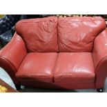 Modern Red Leather Covered 2-Seater Sofa, on raised feet, 66”w