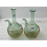 Pair of Continental Green Glass Bottle Ewers with ice compartment, in wicker cases