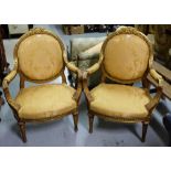 Matching Pair Ornate Gilt framed open Armchairs, gold satin fabric.