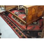 Persian Wool Floor Rug, red ground with central medallions and multiple black patterned borders,