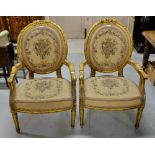 Matching Pair Carved Gilt Open Armchairs, with floral tapestry seats and backs.