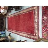 Large red ground Persian Floor Runner, with all over central paisley designs, multiple pattern beige