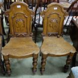 Matching Pair WMIV Oak Hall Chairs, the backs featuring mouldings and crests, on turned front legs.