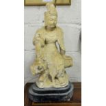 Electric Table Lamp in the form of a tall carved wood Buddha figure on a wooden stand, with brass