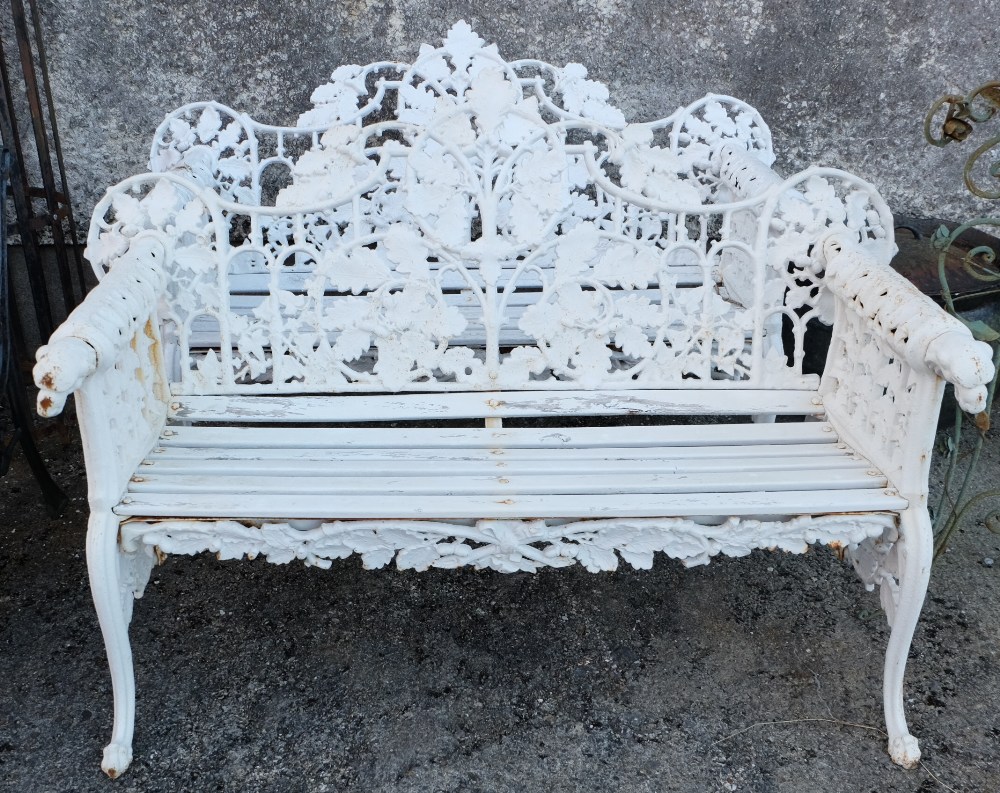 Matching Pair of Cast Iron Garden Seats, with pierced backs, mounted with dog heads at arms, 58”w