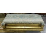 Carved Gilt Footstool, painted gold, the padded top covered with blue velour fabric, on 4 raised