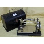 Miniature “Ideal” steel sewing machine, with original tin case