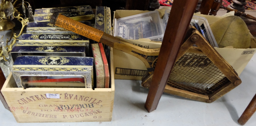 Box of old biscuit tin lids (Jacob & Co) & box of pen re-fills etc, old rugby ball & wooden tennis