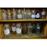 3 shelves of glass Chemist Jars, most with stoppers and labels (32 approx)