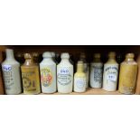 Shelf of Stoneware Ginger etc Bottles, many stamped - 1 Cork, Maddens, Derby, Beaufoy (21 approx)